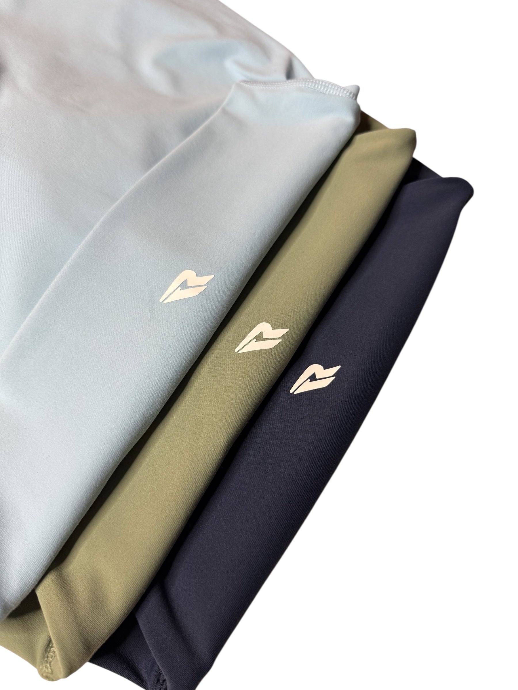 Four folded leggings in gray, white, beige, and navy with a logo on a white background